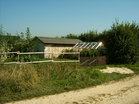 Die Einfahrt - der Zaun ist aus Kastanienholz (kriegt man recht günstig in ebay), das Tor besteht aus zwei alten Zaunfeldern eines modernisierten Nachbarhauses--- zur Hütte und zum Gewächshaus später mehr